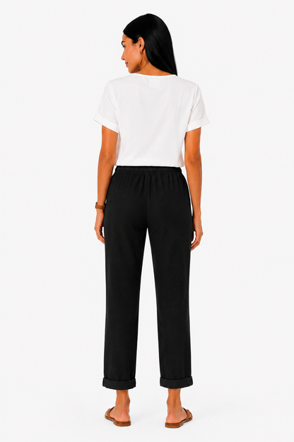 Pantalón fluido con cintura elástica de la marca Vera Serrat, en color oscuro, con dobladillo recto y tejido ligero.